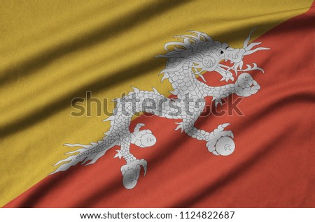 Bhutan flag  is depicted on a sports cloth fabric with many folds. Sport team banner