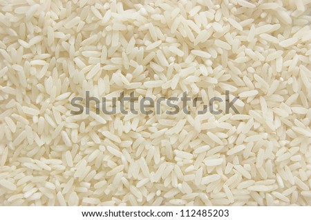White long rice background, uncooked raw cereals, macro closeup Royalty-Free Stock Photo #112485203