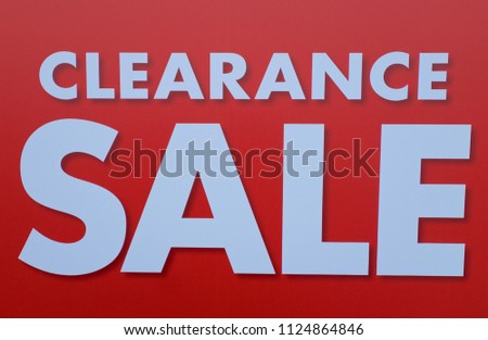 Red and white clearance sale sign.