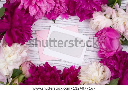 Peony flowers border blank greeting card white wooden background