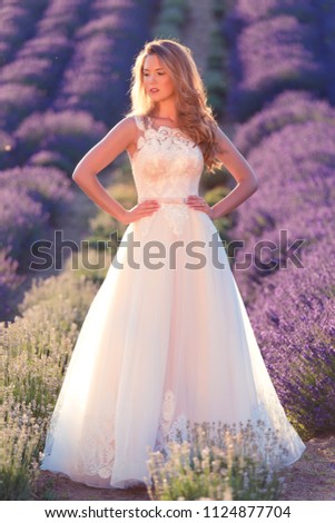 Beautiful bride in wedding day in lavender field. Beautiful blond woman