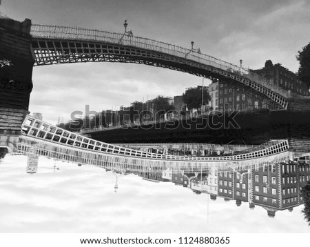 Dublin millennium bridge on Sunday morning with photo upside down to show the reflection of the river on top of pic.