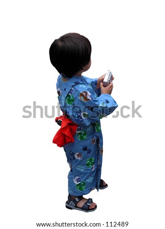A little boy wearing Japanese traditional clothes and handing a digital camera