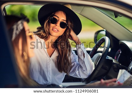 Two young women having fun driving