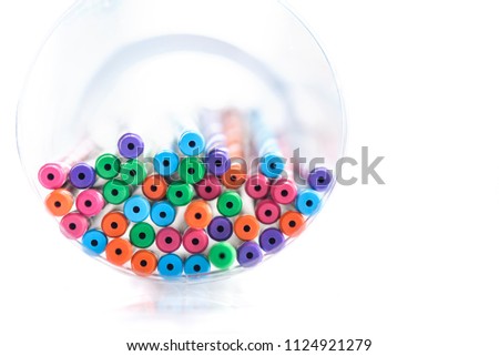 Close up of Colorful pen in plastic box isolated on white background.