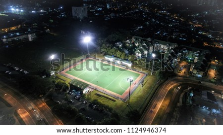 Full-size well-lit football pitch in a small neighbourhood