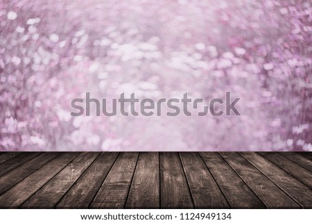 wood table on blur background of pink cherry blossom flower -Mock up for display of product.