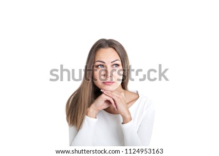 Head and shoulders portrait of a beautiful young woman with fair hair wearing white and thinking looking upwards. Concept of business creative mind. Isolated