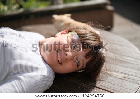 Caucasian girl in transparent glasses with beige mini chihuahua