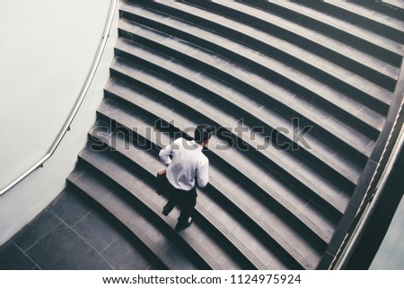 Businessman running fast upstairs Growth up Success concept Royalty-Free Stock Photo #1124975924