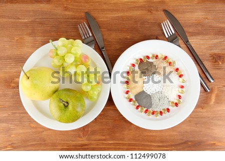 Nutritional supplements on wooden background close-up