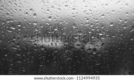 Close up raindrops on window. Summer rain weather. Blurred gray background. Copy Space. Macro view of raindrops. 