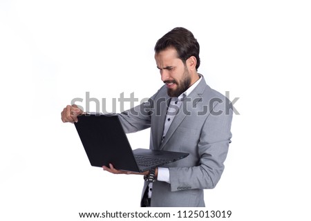 Businessman wearing a suit and holding his laptop and he read a bad news looking very sad, isolated on white background.