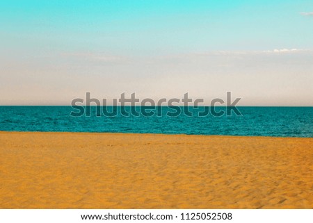 golden sand on the beach on blue water of sea 