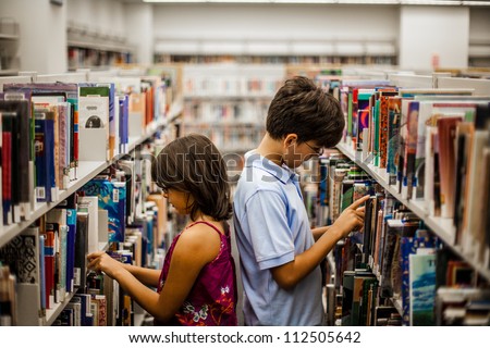 Teenager in a library are reading books