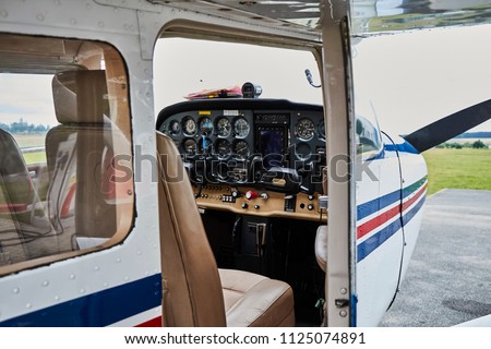 Detailed view of Cessna airplane interior standing on a runway. Royalty-Free Stock Photo #1125074891