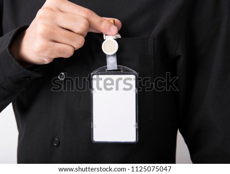 employee hand showing blank id card badge holder for mockup template logo branding background. Royalty-Free Stock Photo #1125075047