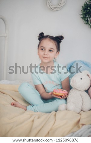 little girl with donuts