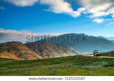 Himalayan valley landscape with road near Kunzum La pass, Spiti Valley, India. Royalty-Free Stock Photo #1125133187