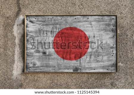 
Wooden nameplate on the wall with a painted flag of Japan on it