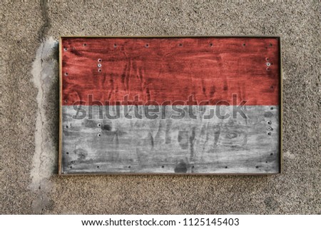 
Wooden nameplate on the wall with a painted flag of Indonesia on it