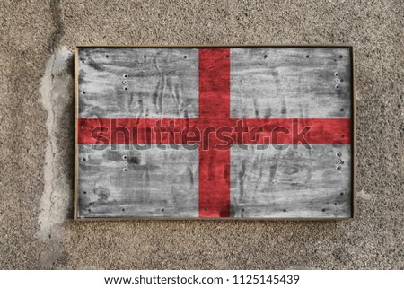 
Wooden nameplate on the wall with a painted flag of England on it