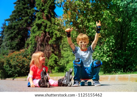 happy kids on roller skates and skateboard outside