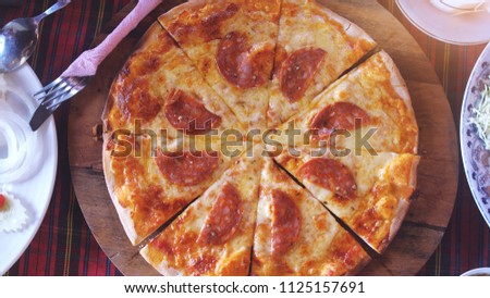 Top view of appetizing pizza with salami