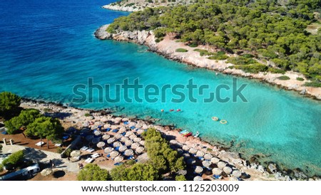 Aerial bird's eye view photo taken by drone of Aponisos beach and lake with clear turquoise waters and pine trees,  Agistri island, Saronic gulf, Greece