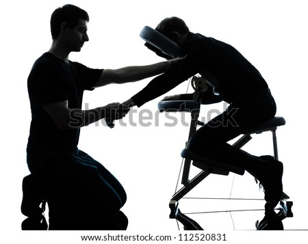 two men performing chair back massage in silhouette studio on white background