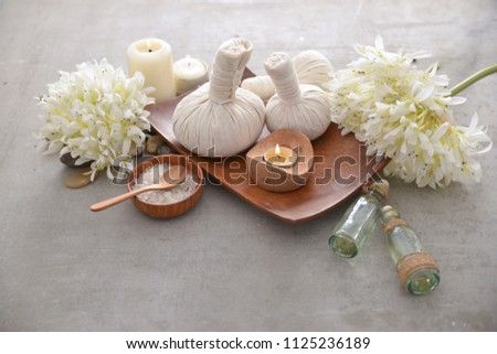 Spa setting with candle,spoon, salt, in bowl ,soap with Bouquet of hydrangea ,oil,on gray background
