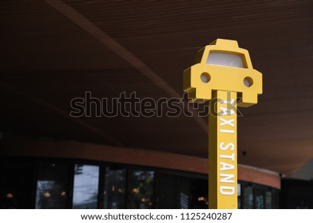 Closeup of beautiful yellow taxi stand  with interior background, sign of good public service.