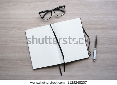 Flat lay stylish mockup photo with a blank notebook and a pencil on the light wooden background. Stock photo for blog and website.