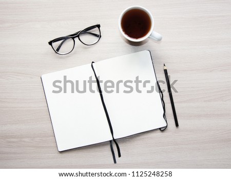 Flat lay stylish mockup photo with a blank notebook and a pencil on the light wooden background. Stock photo for blog and website.