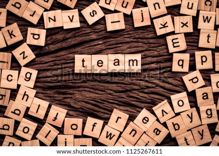 Team word written cube on wooden background. Vintage concept.
