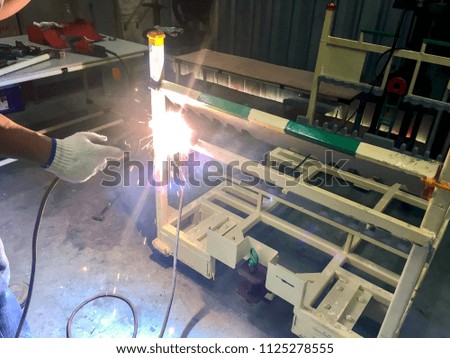 welding with sparks,welder works
Industrial steel part in factory,over light,close-up,