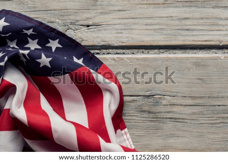 American stars and stripes flag on a white wooden plank background