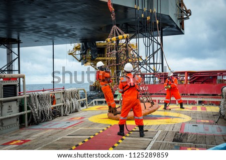 Personal basket tranfer form  supply boat to oil&gas rig offshore during crew change by boat. Royalty-Free Stock Photo #1125289859
