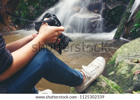 Close up of woman photographer with camera in the beautiful nature