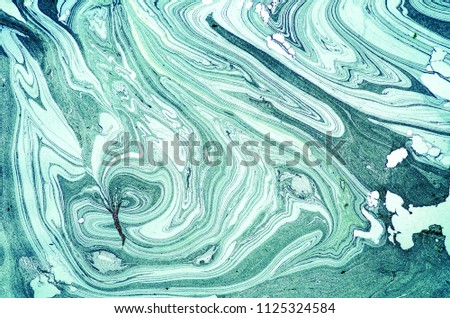 Suminagashi – The ancient art of Japanese marbling. Paper marbling is a method of aqueous surface design, which can produce patterns similar to smooth marble or other kinds of stone. Natural luxury. Royalty-Free Stock Photo #1125324584