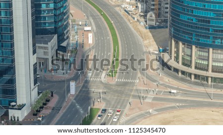 Top view city traffic on a crossroad in Dubai Downtown near Business bay timelapse. Aerial top view of road junction from above, automobile traffic and jam of many cars, transportation concept