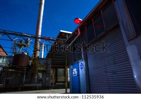 An old abandoned factory scene at night. Long exposure light painting
