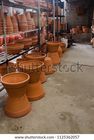 Terracota plant pots in greenhouse for sale