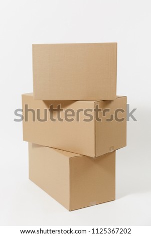 Stacked of three brown clear empty blank cardboard boxes isolated on white background. Receiving package. Copy space for advertisement. With place for text. Advertising area with workspace