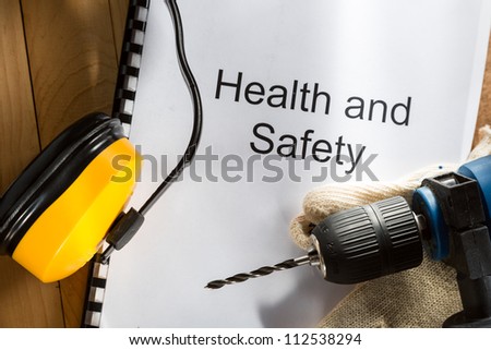 Register with drill and gloves on wooden background