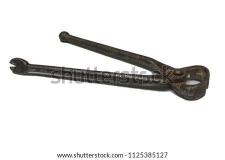 Old, second-hand, rusty tongs. Royalty-Free Stock Photo #1125385127