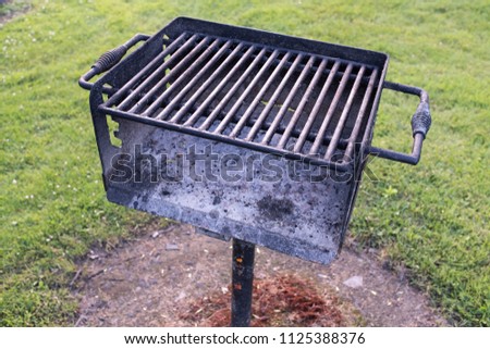 Bar-B-Que Grill At A Campsite With Green Grass Royalty-Free Stock Photo #1125388376