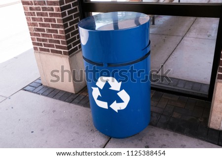 Blue Recycle Bin On The Street Royalty-Free Stock Photo #1125388454