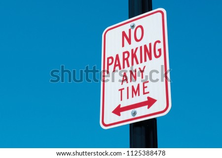 No Parking Sign On A Pole With Blue Sky Royalty-Free Stock Photo #1125388478
