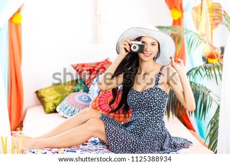 Beautiful woman Photographer making pictures with retro hipster camera having fun at the vacation. Summer lifestyle